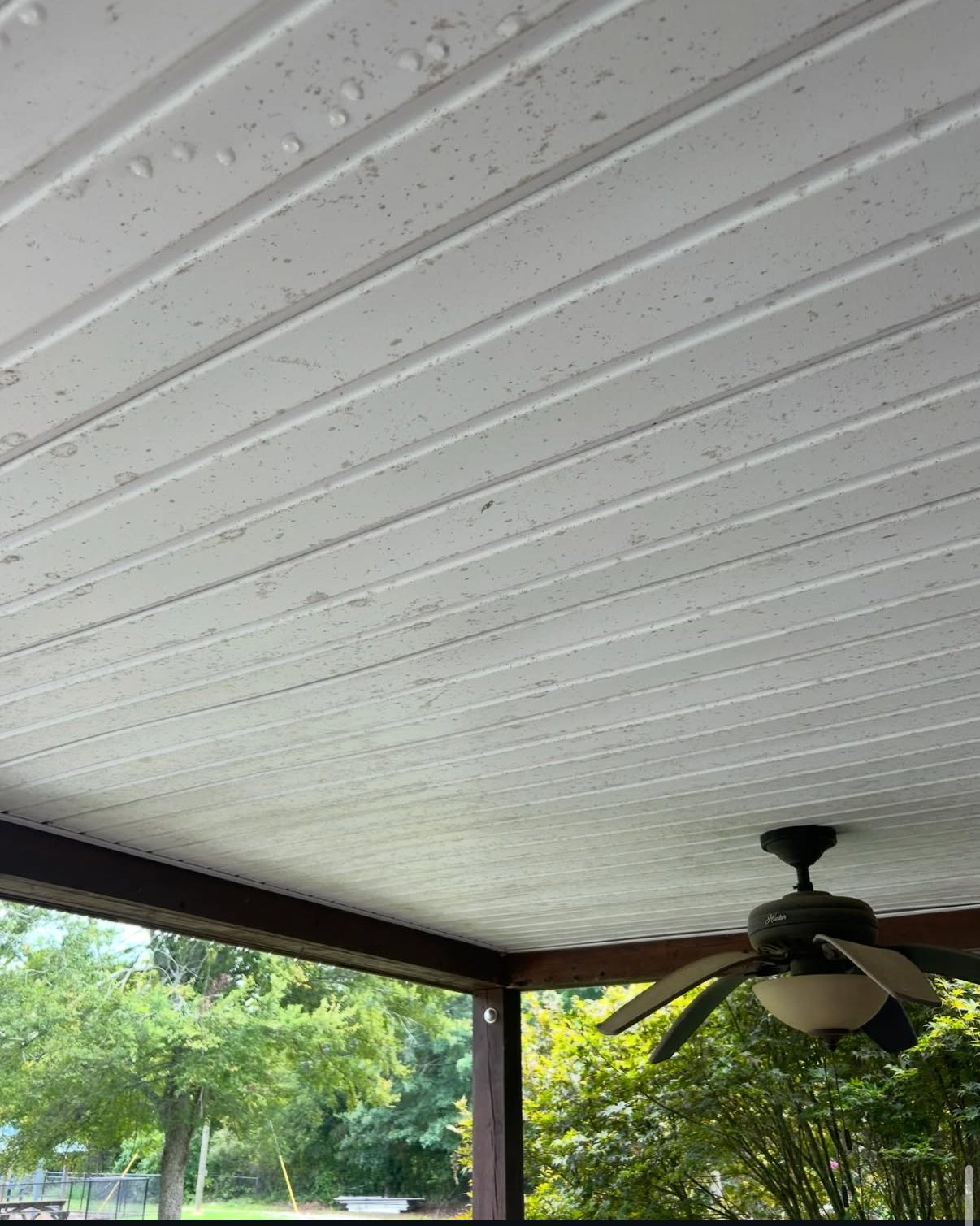 Stained porch ceiling before cleaning in Athens, GA