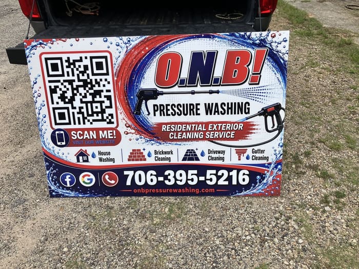 O.N.B Pressure Washing sign listing house washing, brickwork, driveway, and gutter cleaning