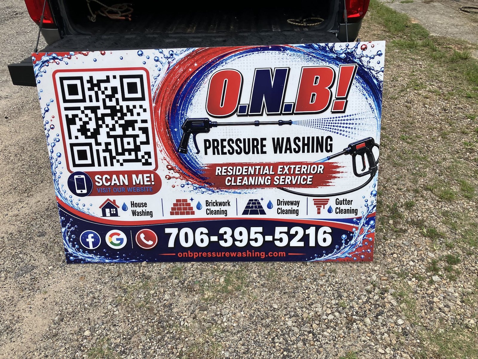 O.N.B Pressure Washing sign listing house washing, brickwork, driveway, and gutter cleaning