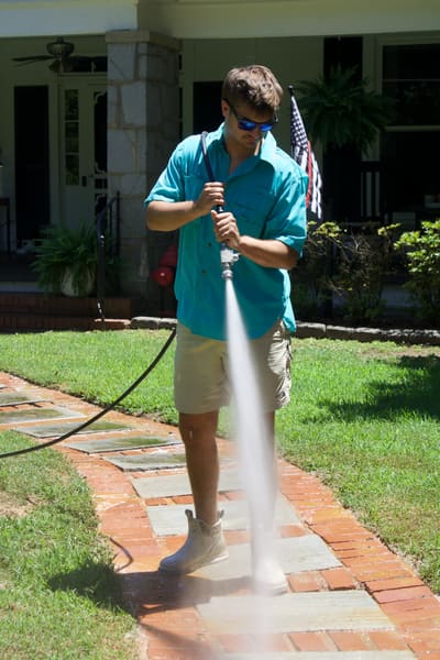 O.N.B technician pressure washing a sidewalk in Athens, GA